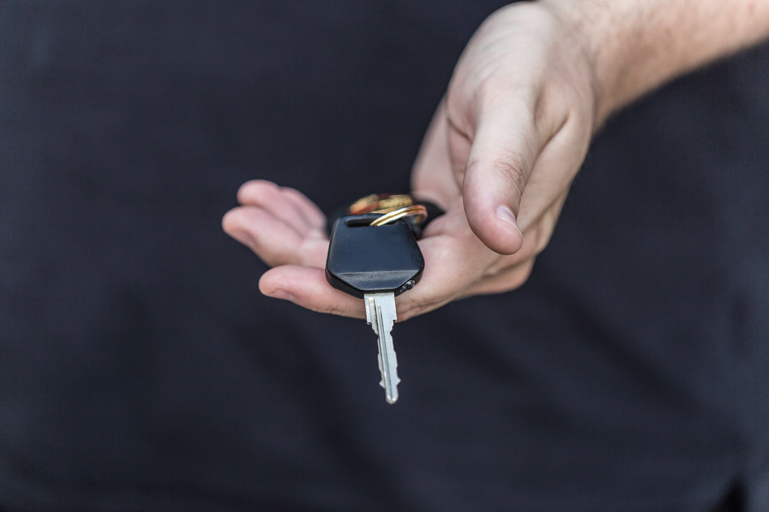 Learner driver holding car keys after passing their driving test successfully
