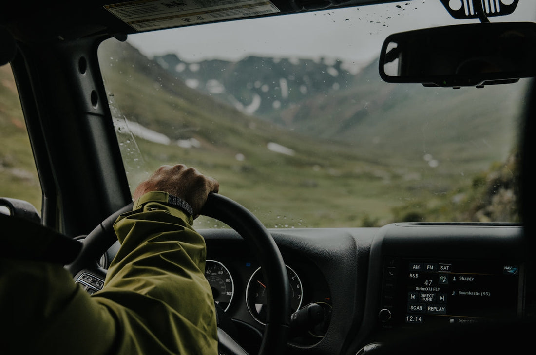 Learner driver practising confident driving on a scenic Highlands road during daytime